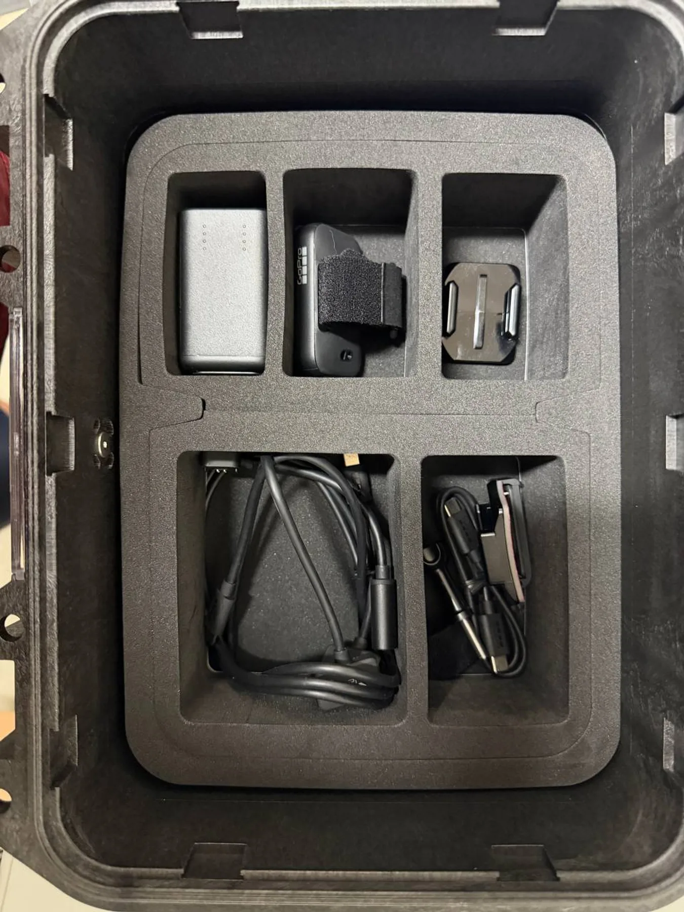 GoPro HERO13 accessories and chargers in lower case tray