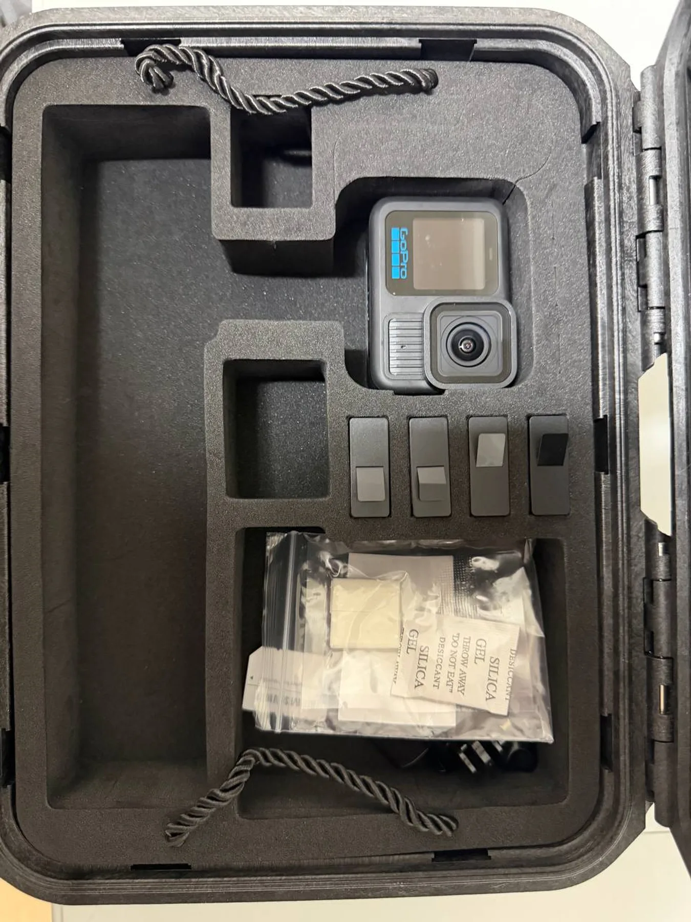 GoPro HERO13 Black with four batteries visible