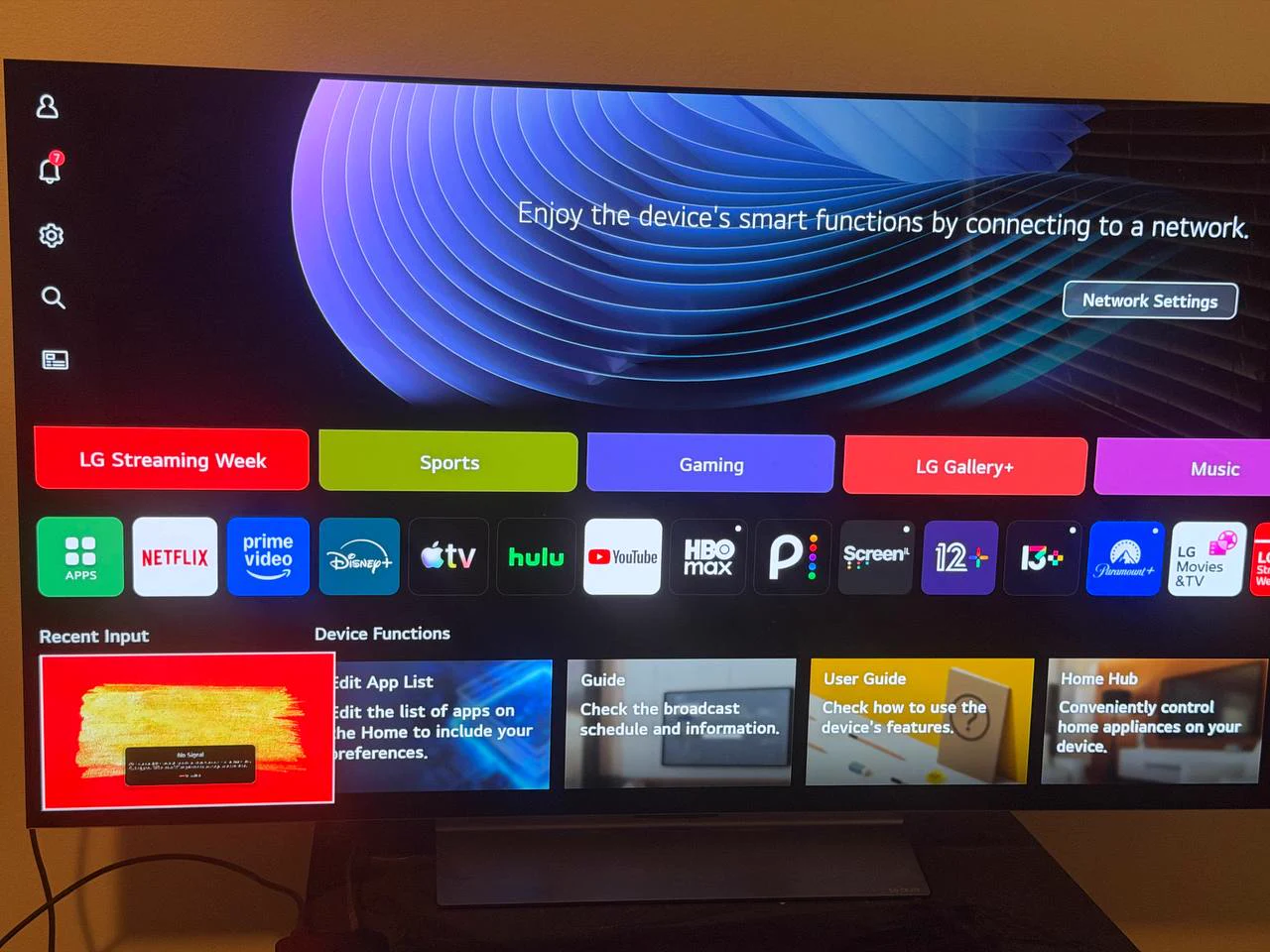 LG C4 55-inch OLED TV powered on with original stand